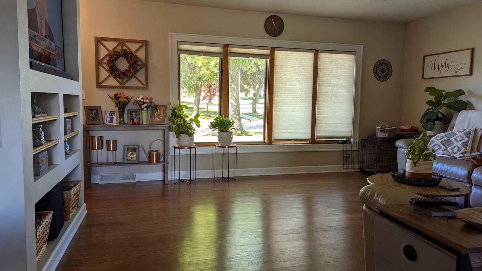Bright renovated living room in Cudahy, WI with refinished hardwood floors and custom built-in shelving