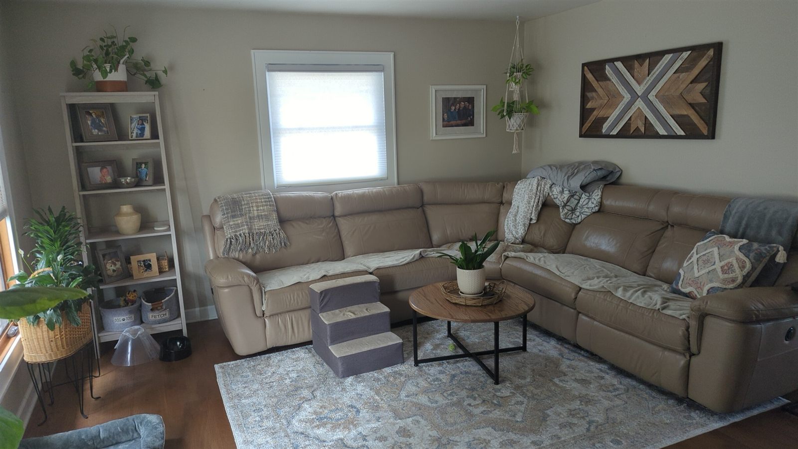 Cozy renovated living room with fresh paint, hardwood floors, and geometric wood accent art